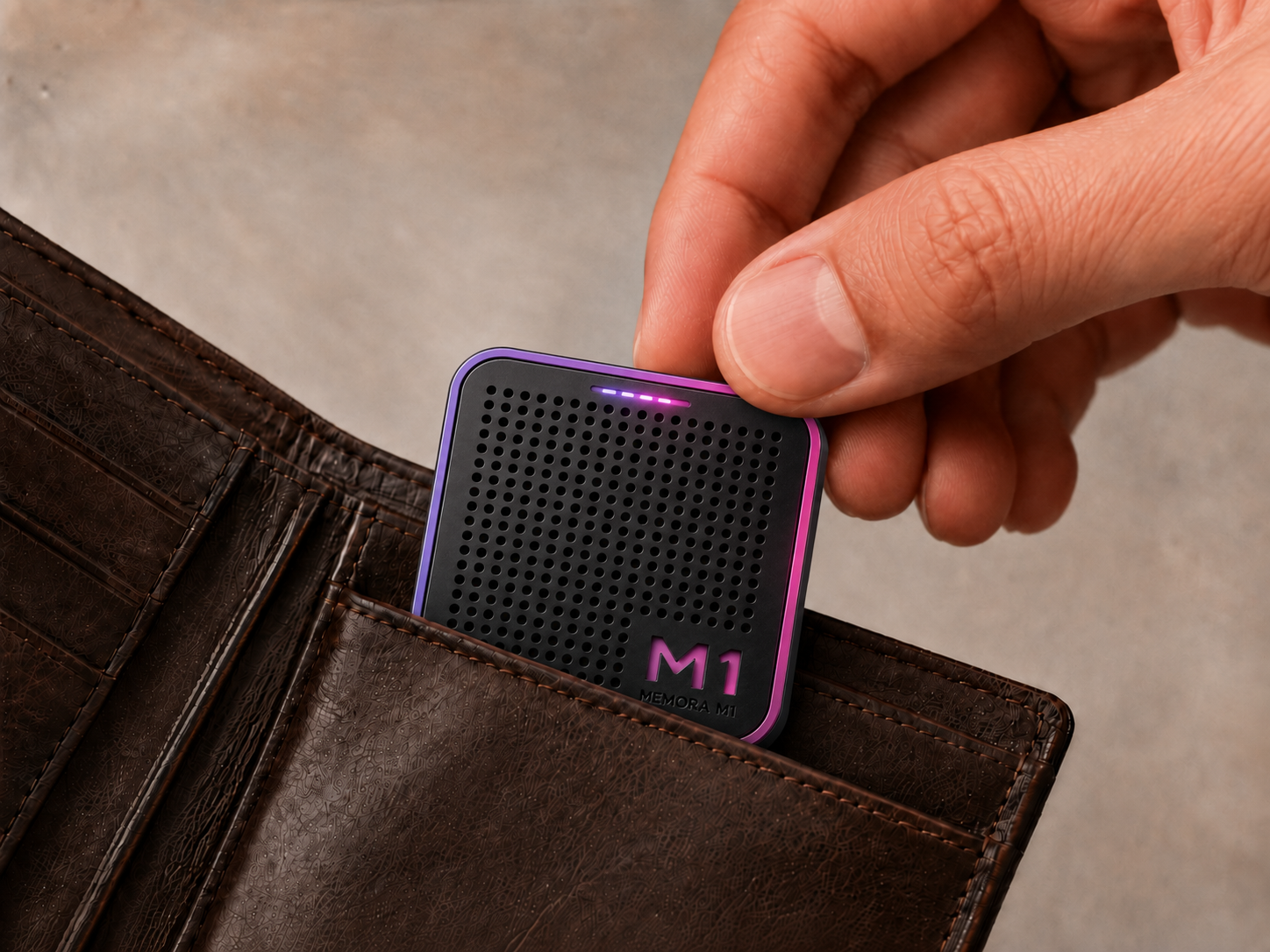 The Memora M1, a small black speaker with a gradient rim and dimpled grille